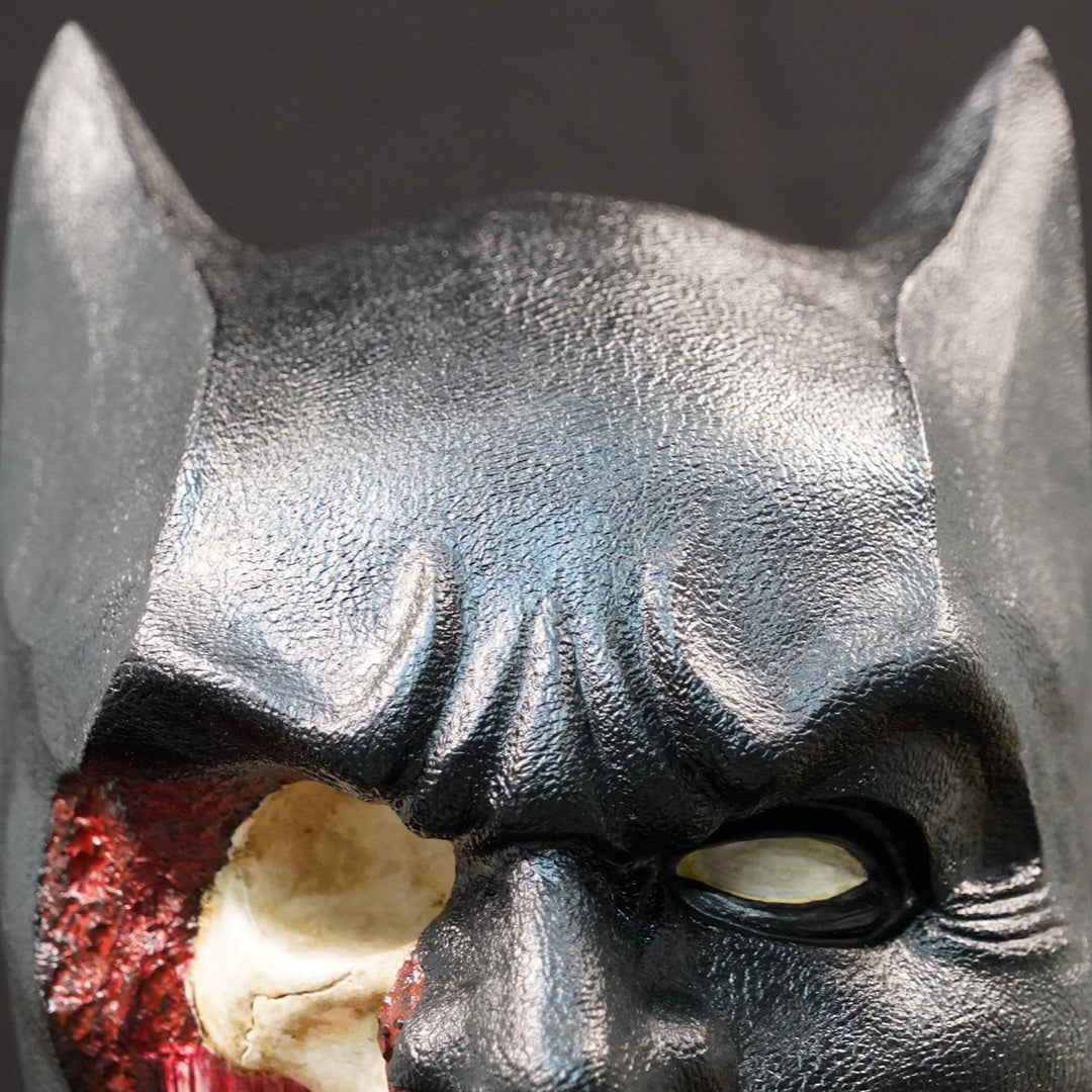 Shadow Knight statue head in dark textured resin; close-up reveals a damaged area with red and bone interior.