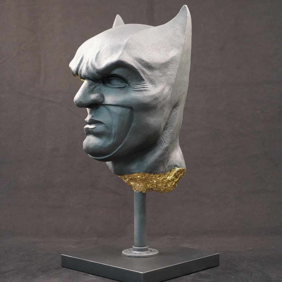 Shadow Knight – Matt Black Gilded, front-right three-quarter view. Matte black bust with gilded fractures exposing skeletal anatomy beneath the surface.