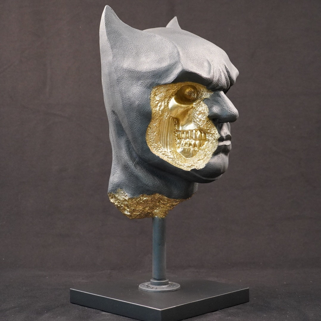 Shadow Knight – Matte Black Gilded sculpture, front-left three-quarter view. Matte black masked bust with gold-leaf fracture details exposing internal skeletal features.