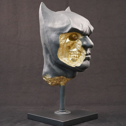 Shadow Knight – Matte Black Gilded sculpture, front-left three-quarter view. Matte black masked bust with gold-leaf fracture details exposing internal skeletal features.