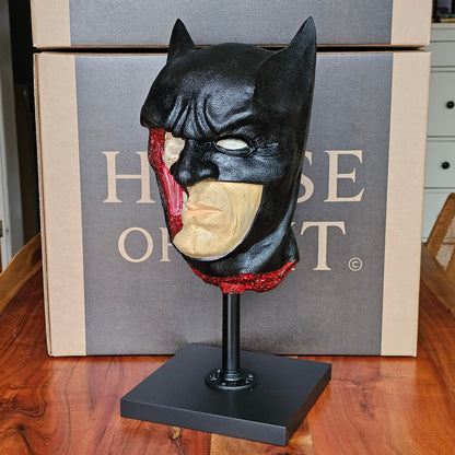 Bat-themed superhero mask sculpture with anatomical cutaway revealing skull and muscle structure