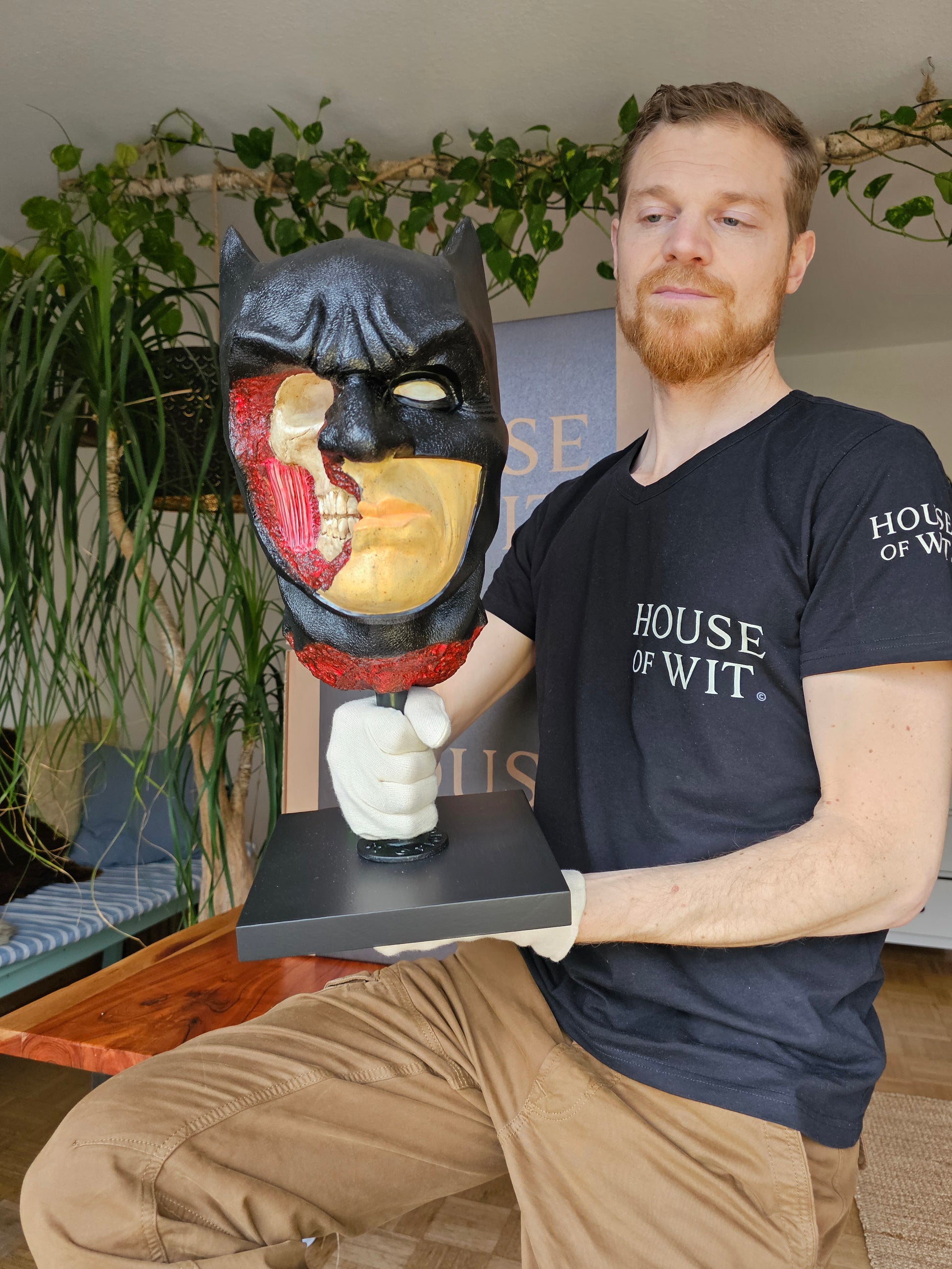 “House of Wit Batman anatomical bust on black stand, front view showing stern expression and black cowl.”