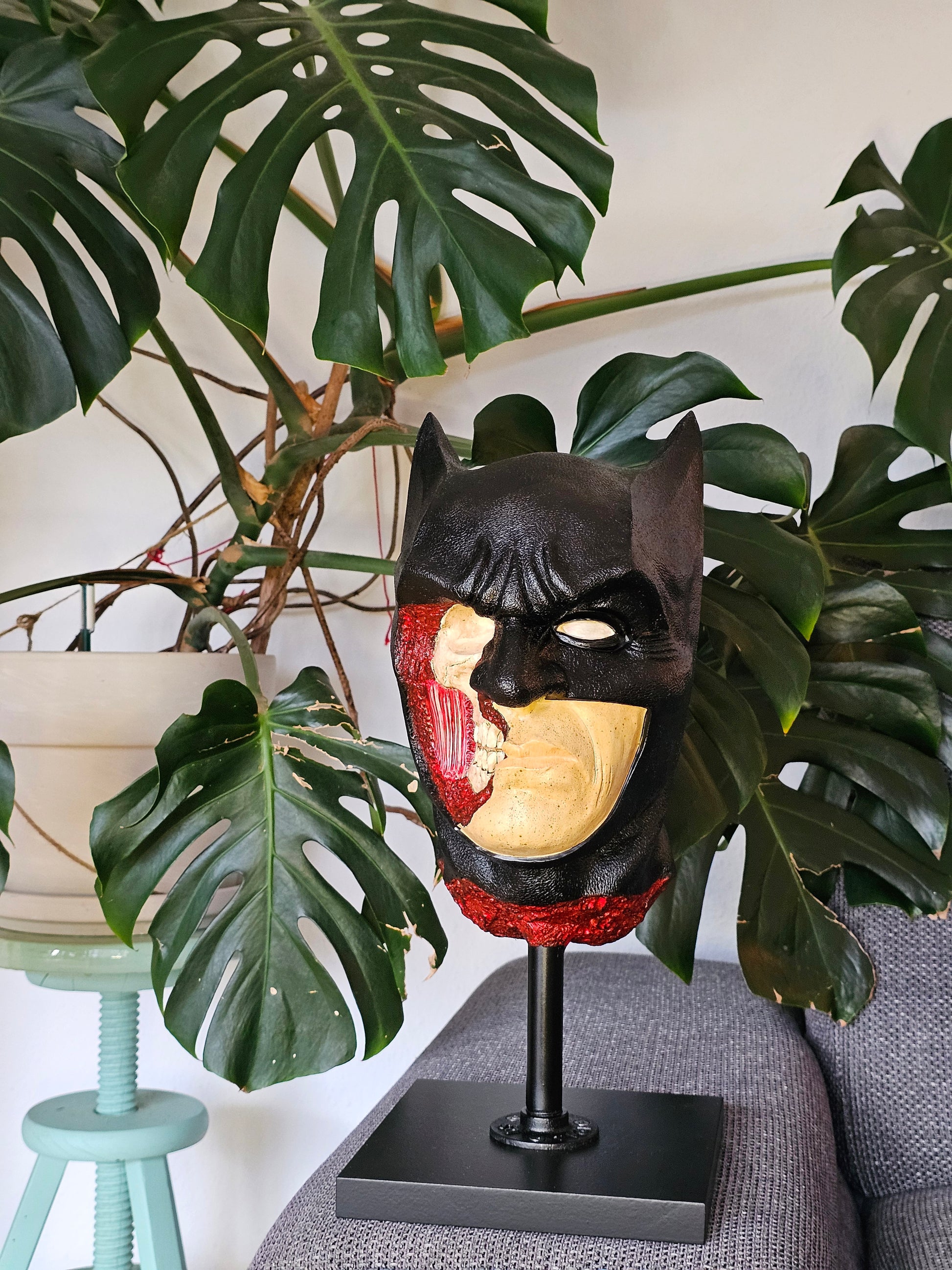 “Batman anatomical bust by House of Wit styled on a shelf, used as dark art decor in a modern interior.”

